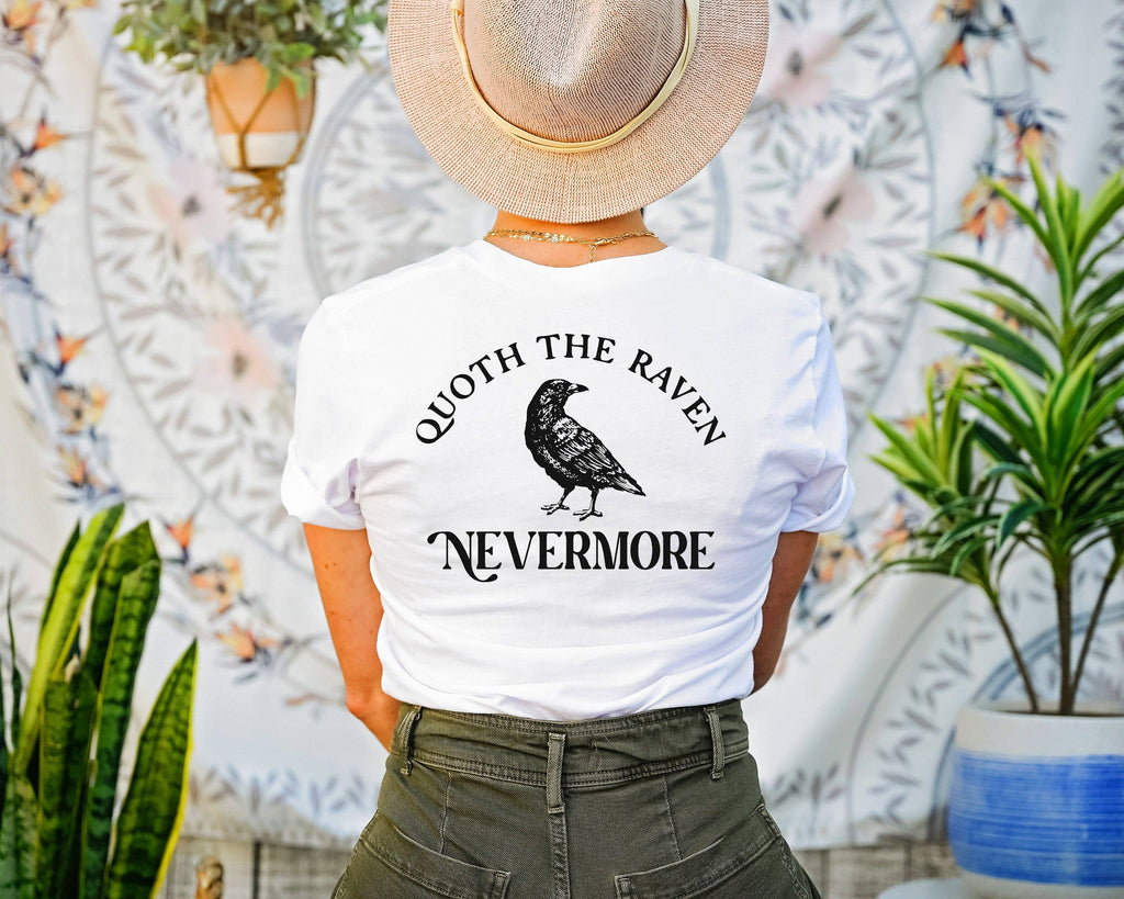 White t-shirt with a pocket size Edgar Allen Poe on the front, left and Quoth the Raven Nevermore centered on back with an image of a raven.