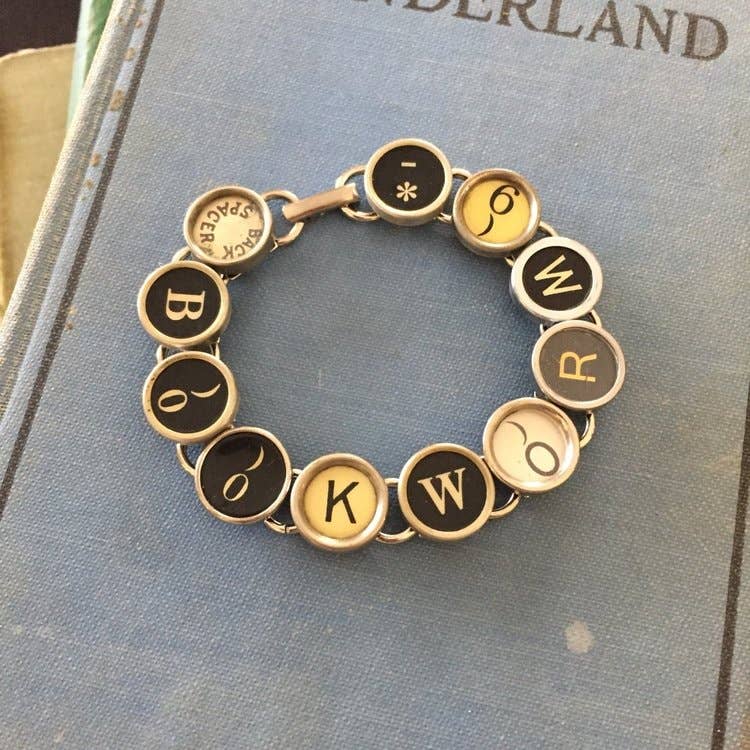 Linear bracelet with real vintage recycled typewriter keys that read "Bookworm."