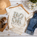 Beige t-shirt with the word bookworm filled with yellow wildflowers.