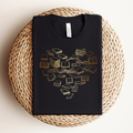 Black t-shirt with cream to gold ombre colored books in the shape of a heart.