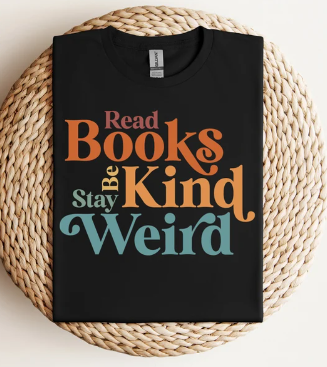 Black t-shirt with colorful words that says read books, be kind, stay weird.