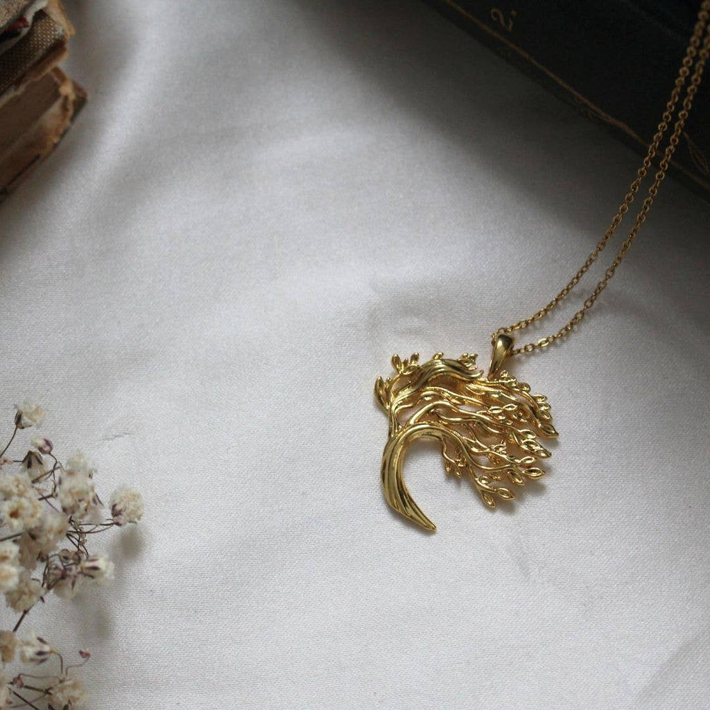 Gold tone necklace depicting a tree with wind swept branches, a tribute to Wuthering Heights.